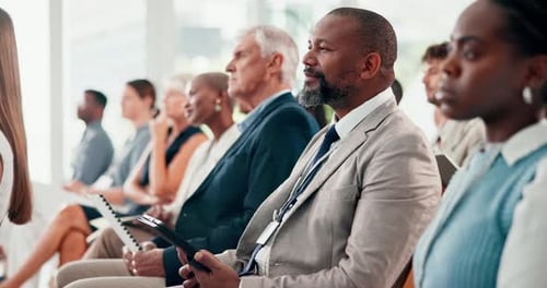 Business, learning and man in audience at seminar with agreement of information from workshop