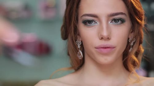 Woman Getting Makeup Applied by Artist