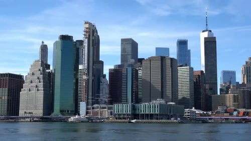 Lower Manhattan and New York Harbor on a sunny day with blue skies