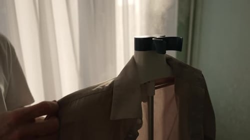 Steaming Wrinkles From Shirt with Clothes Steamer