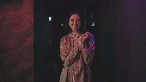 Woman Smiling in Dark Urban Alleyway at Night