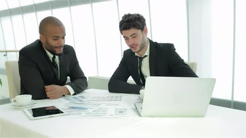 Dynamic Discussion Among Young Professionals in a Modern Office
