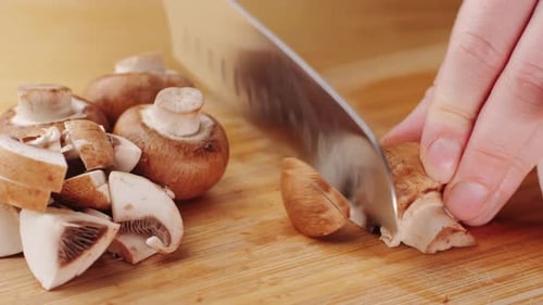 Chef Cutting the Mushrooms on a Wooden Board with Knife Mushroom Cooking Close Up