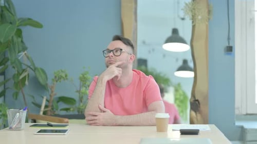 Pensive Creative Man Thinking while Sitting