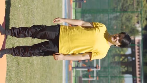 Young Adult Stretching Hamstrings Outside in Sunlight