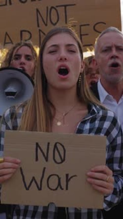 People Protest, Hold Signs in Street Demonstration