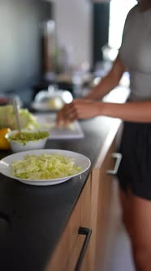 Woman Preparing a Salad in the Kitchen