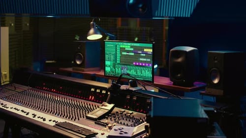 Audio Mixing Board and Monitor in Dark Studio