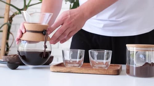 Man prepares coffee in style pour over
