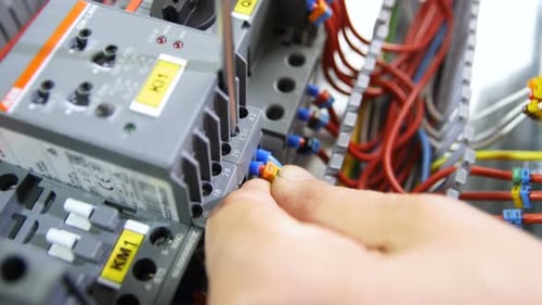 Electrician Connects Cable to Case with Screw