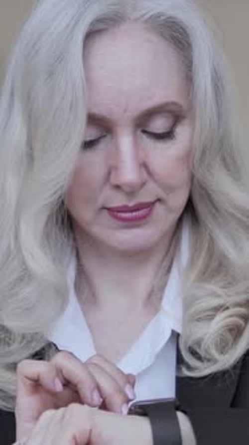 Woman in Business Attire Using Smart Watch