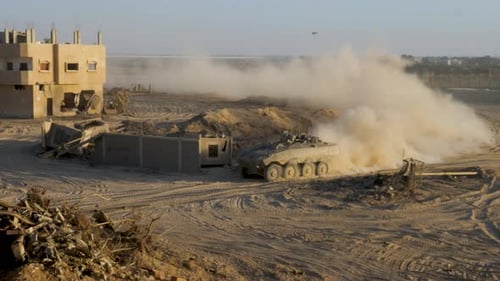 Driving armoured vehicle through destroyed Gaza City with bombed buildings