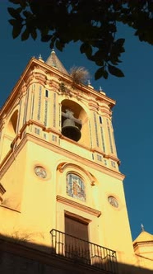 Sunshine Illuminates Historic Bell Tower Peaceful City Square With Illuminated Ornate Bell Tower