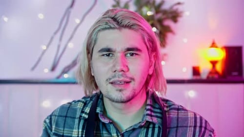 Blond Haired Man Holding DSLR Camera