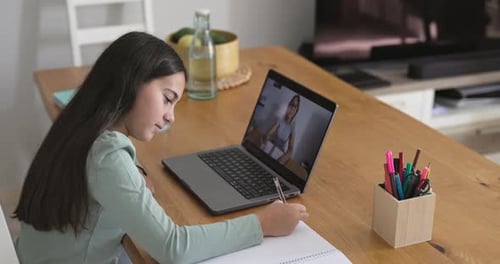 Teenager girl doing private school class using laptop at home - Education