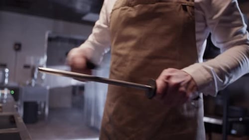 Chef Sharpening Knife with Steel in Commercial Kitchen