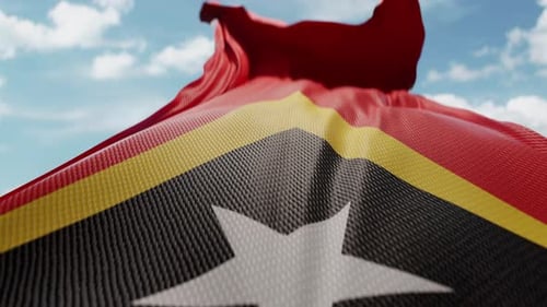 Timor-Leste Flag Waving in Blue Sky