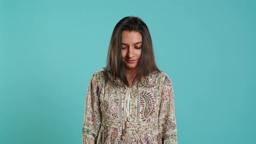 Young Woman Smiling Fashion Portrait Against Blue Backdrop