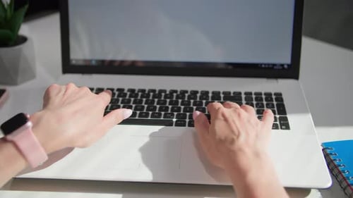 Woman's Hands Typing on Laptop Keyboard