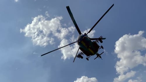 Military Helicopter Flying Through Cloudy Sky