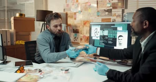 Man, detective and talk with evidence in office for investigation, killer weapon and review case