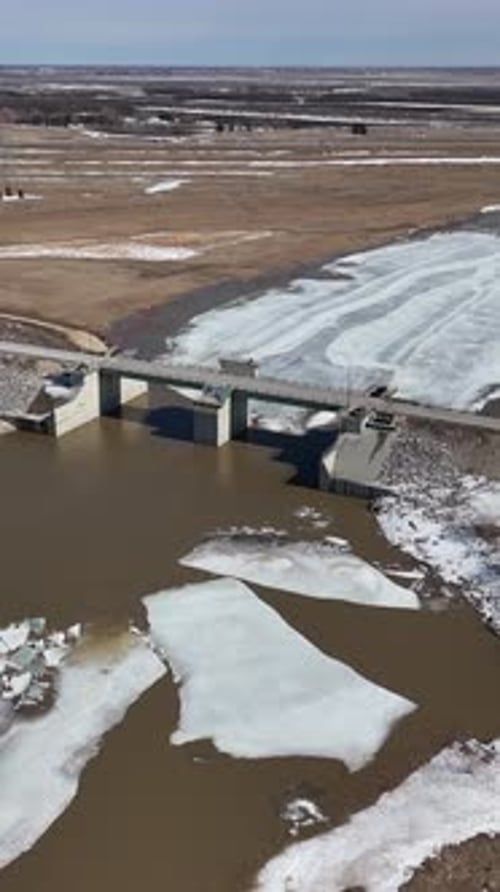 Red River Floodway Gates Winnipeg Manitoba Canada Aerial Vertical Orbit In Descend Spring Breakup