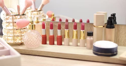 Different makeup products on wooden table, closeup