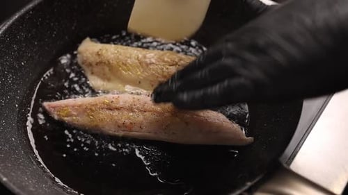 Fish Fillets Frying in Pan on Stove Top