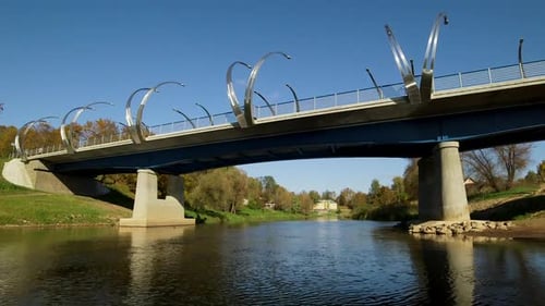 View from a Boat Passing Under a Beautiful Bridge with Arches on the River.