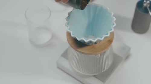 Coffee Beans Pouring Into Bright Blue Coffee Dripper