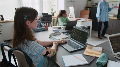 Girl with Prosthetic Arm Attending Programming Lesson