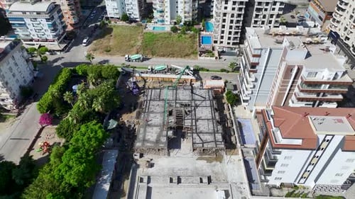 Aerial View Workers Pouring Foundation Concrete and Bending Rebar at Site