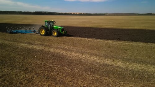 Tractors plowing the field in Ukraine