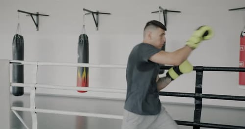 Man Boxing in the Ring at the Gym