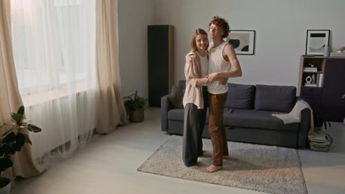 Young Couple Tenderly Dancing Together at Home