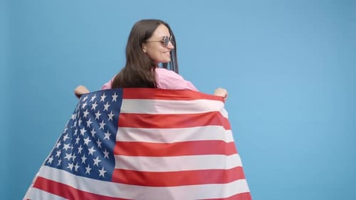 Smiling Woman Wrapped in American Flag