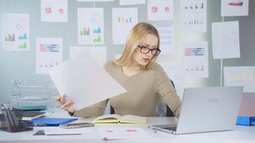 Young Adult Woman Works With Data in Office