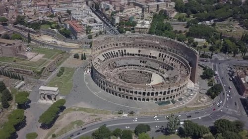 Aerial orbits Roman Colosseum and Constantine Arch in Rome, Italy