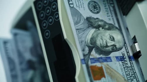 Currency Counter Counts Stack of Hundred Dollar Bills