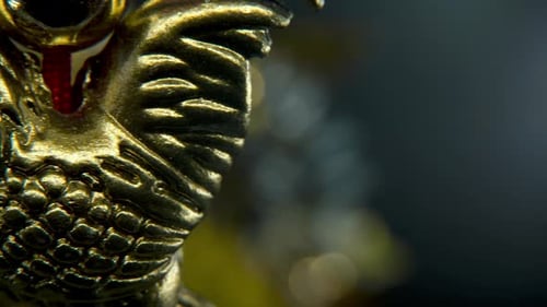 Chinese New Year traditional golden chicken zodiac statue, hanging shiny gold rooster sitting on mon