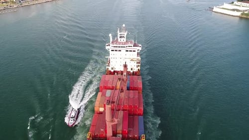 An expensive ocean showcases an aerial view of a cargo container ship