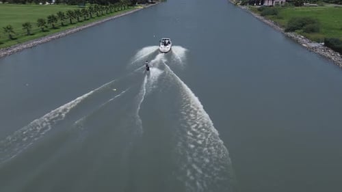 Aerial view of a wakeboarding sport boat practice on the lake with calm water