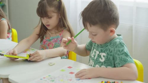 The Girl Chooses a Colored Pencil the Boy Completes the Task