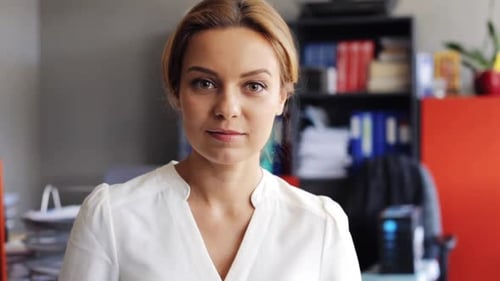 Happy smiling middle aged businesswoman at office expressing joy and success