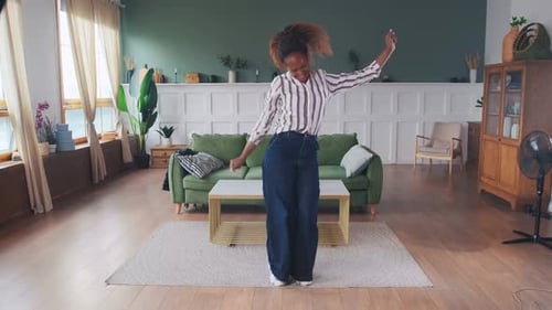Woman Dancing Happily in Her Living Room
