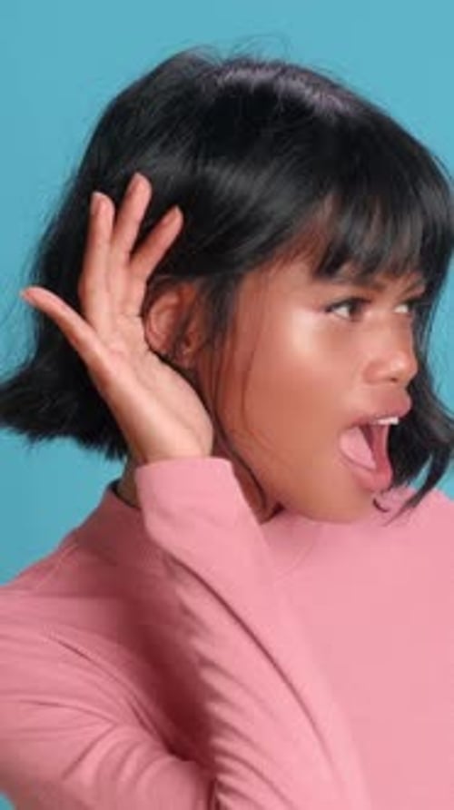 Young Woman Listening Intently With a Surprised Expression