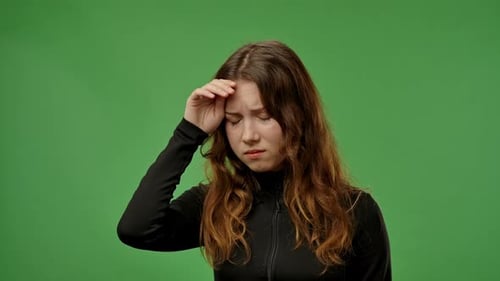 Teenage Girl Posing at Camera and Having Fever Touching Forehead with Hand Feeling Unwell Tired