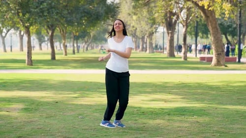 Woman Exercising in City Park on Sunny Day