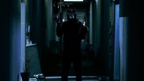 Menacing Figure with Skull Mask and Knife in Hallway