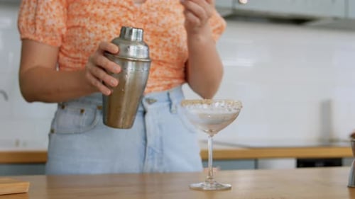 Woman Makes Cocktail Drink in Kitchen Environment
